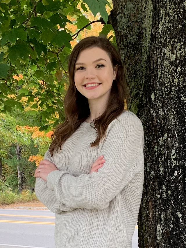 Headshot photo of Elizabeth Mellen outside leaning against a tree